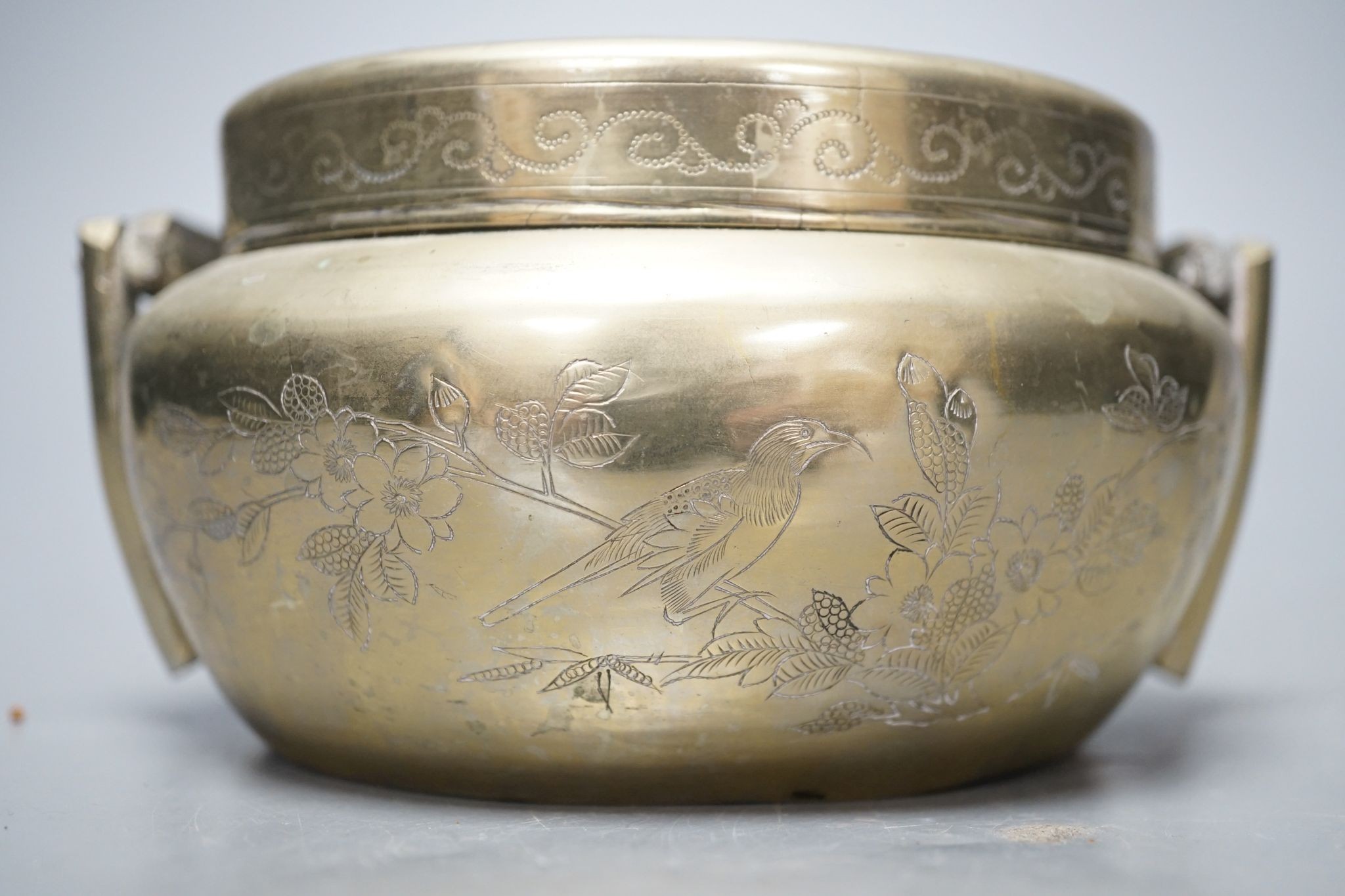 A Chinese bronze tripod censer, 13.5cm and two brass or bronze hand warmers